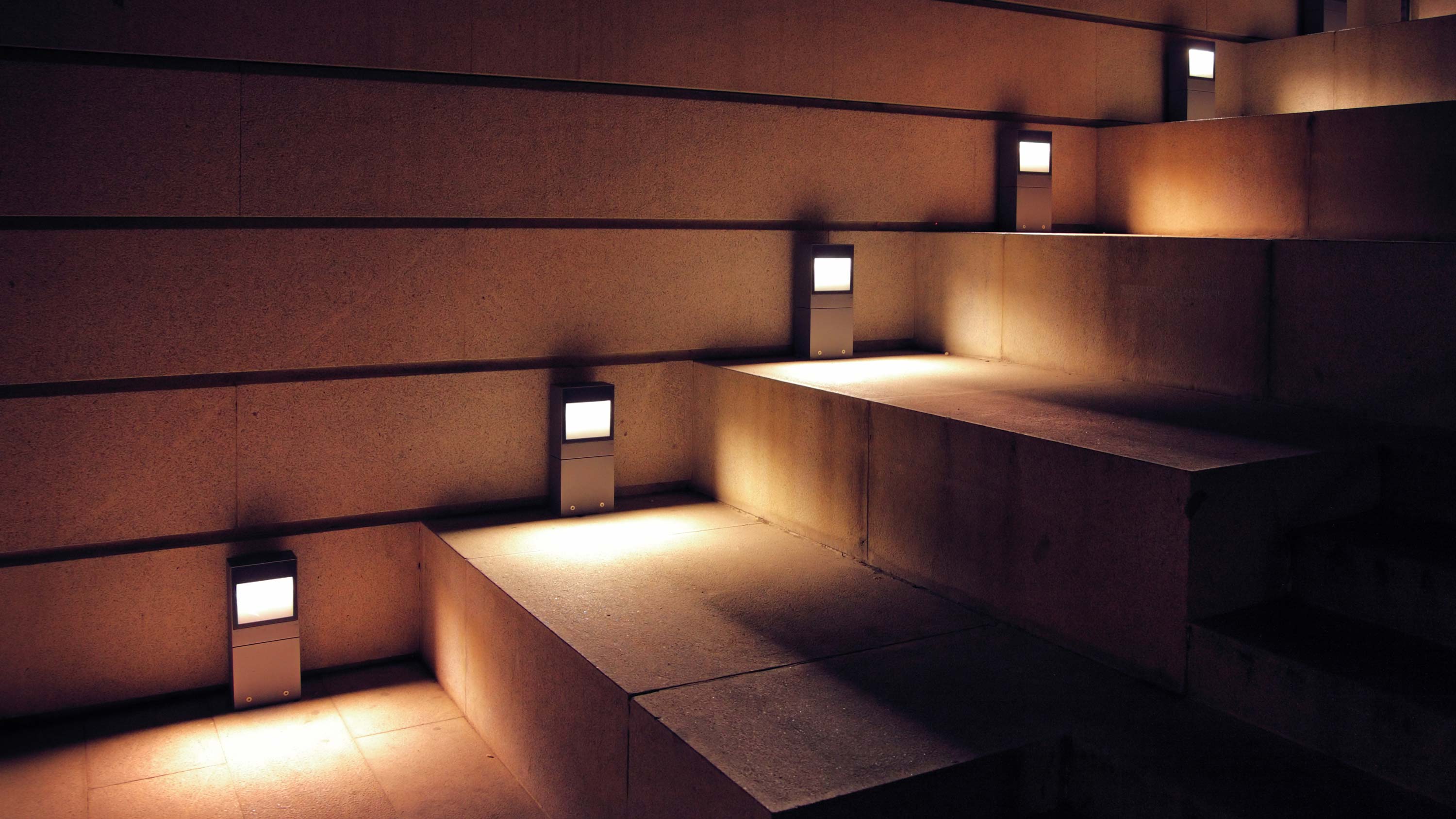 A well-lit pathway with modern ground and bollard lights enhancing safety.