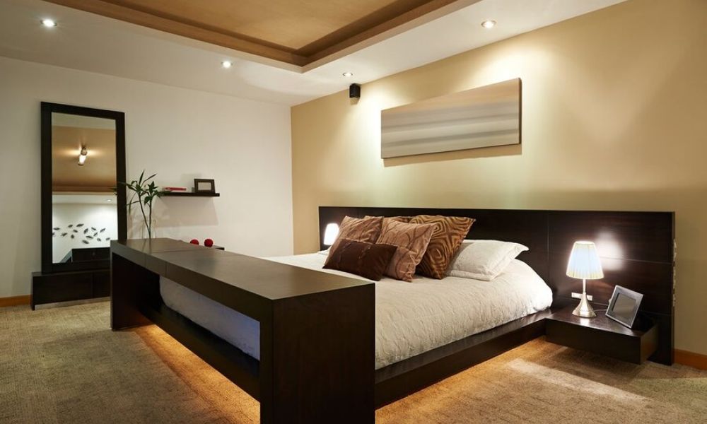 A bedroom illuminated by various smart lighting fixtures.